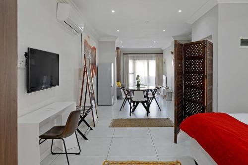 a bedroom with a table and a room with a bed at Nazari House in Cape Town