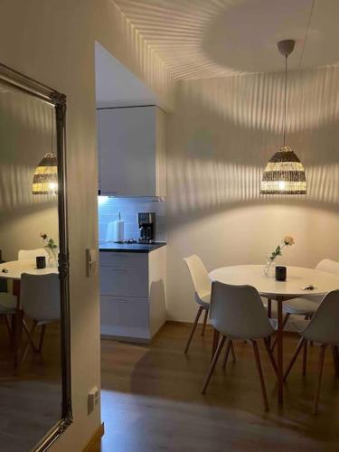 a dining room with a table and chairs and a kitchen at Bronx - Apartment in Vantaa