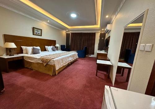 a large hotel room with a bed and a desk at فندق نسيم أبها in Abha