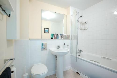 a white bathroom with a sink and a toilet at Luxurious Top Floor 2 Bedroom by Westfield and ABBA! in London