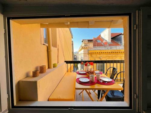 une table avec des assiettes de nourriture sur un balcon dans l'établissement Beautiful Top Floor & Terrasse (Beach 1' walk), à Nice