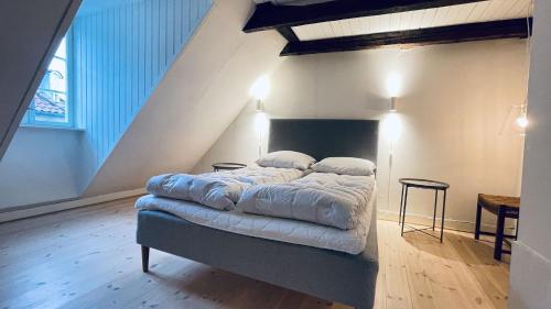 a bedroom with a bed in a attic at ApartmentInCopenhagen Apartment 1571 in Copenhagen
