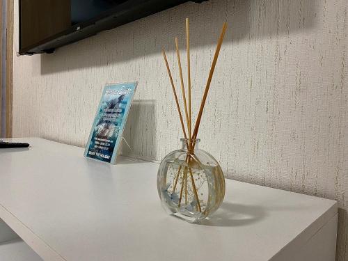 a glass vase with sticks in it on a counter at AVRORA SUITE in Varna City
