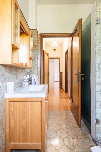 a bathroom with a sink and a hallway at Villa Giulia in Capannori