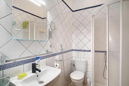 a bathroom with a toilet and a sink and a shower at Haus Brigitte in Playa del Ingles