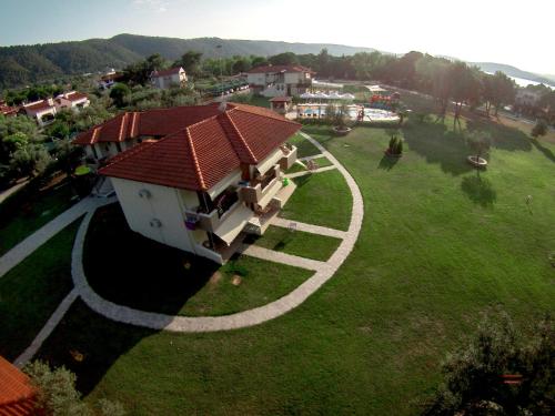 an aerial view of a house with a circle in the grass at Top Studios in Vourvourou