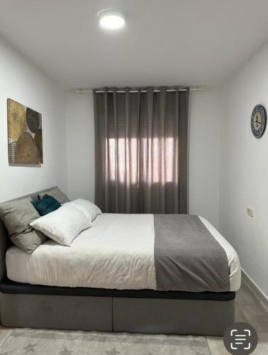 a bedroom with a large bed in front of a window at Apartamento La Timba in Alcossebre