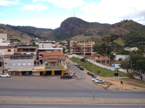 a view of a town with a mountain in the background at QualyLeste Hotel in Caratinga