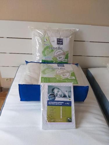a bed with two packages of food on it at Appartement The View in Dinant