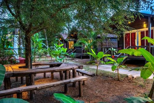 a group of benches in a park with a tree at The Exotica Agonda in Agonda
