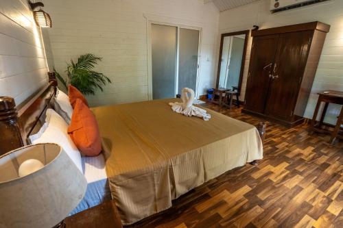 a bedroom with a bed with a stuffed animal on it at The Exotica Agonda in Agonda