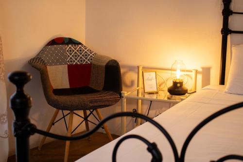 a bedroom with a bed and a chair with a candle at Morfeas Kakopetria in Kakopetria