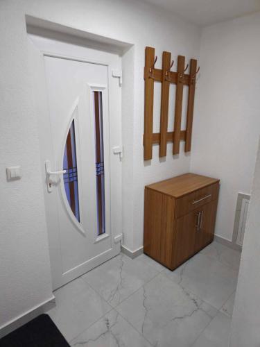 a room with a door and a wooden cabinet at MALM Travnik in Travnik