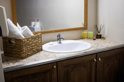 a bathroom counter with a sink and a mirror at Morfeas Kakopetria in Kakopetria