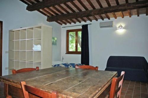 a dining room with a wooden table and chairs at Le Camere Di Paolino in Manciano