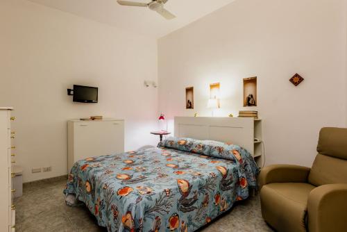 a bedroom with a bed and a couch at Coralie House in Giardini Naxos