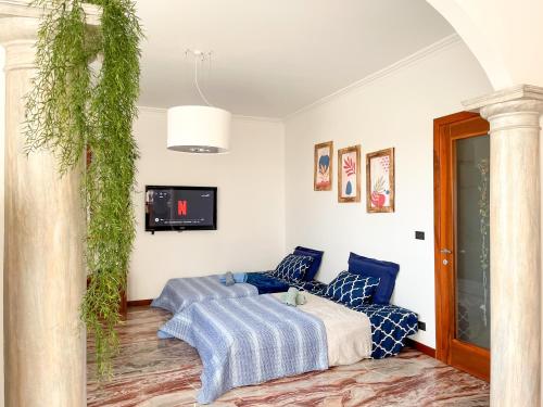 a living room with a couch and a tv at Ornella's apartment - Relax near Venice in Boion