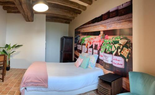 a bedroom with a bed and a wall at LE BAS CHITRAY in Ménil