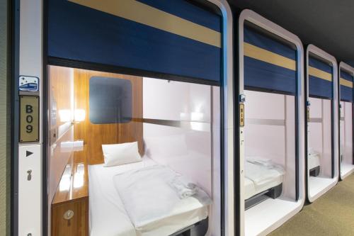A bed or beds in a room at THE S3 Wakayama Station
