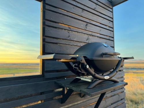 a helmet sitting on a bench next to a building at Eyja Mork - Aurora Dome with Private Bathroom and other facilities in Hvolsvöllur