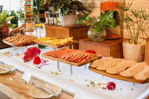 a buffet with different types of bread and cheese at Panorama Beachfront Nha Trang in Nha Trang