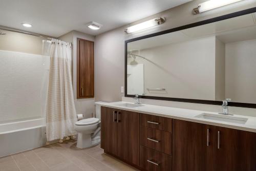 a bathroom with a sink and a toilet and a mirror at Dublin 1br w parking gym ac nr shopping SFO-1460 in Dublin