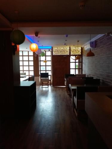 a dining room with tables and chairs and lights at Hotel Mahalaxmi Indo Myanmar in Guwahati