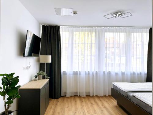 a bedroom with a bed and a large window at Schöne Apartments I private Parkplätze I home2share in Münster