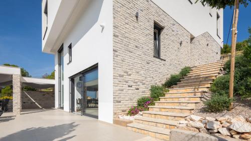a brick house with a staircase next to a building at Villa GRC in Zaboric