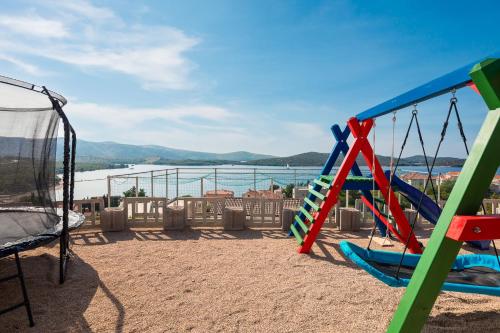 a playground with a seesaw and a swing at Villa GRC in Zaboric