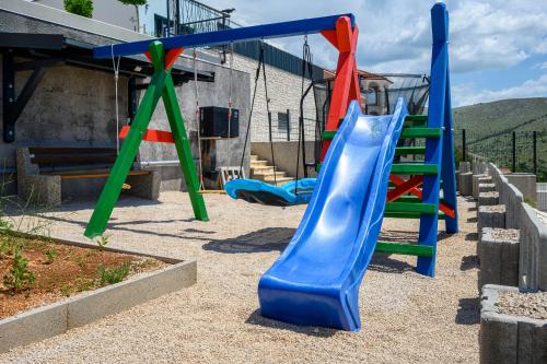 a playground with a slide in a yard at Villa GRC in Zaboric