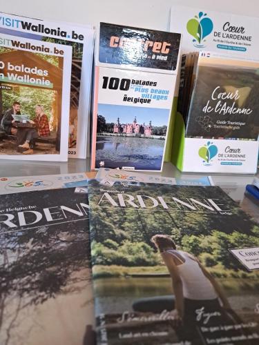 a pile of magazines sitting on a table at Gite A bicyclette in Dinez