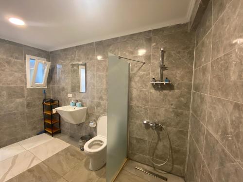 a bathroom with a toilet and a sink and a shower at Mert Homes Marmaris in Marmaris