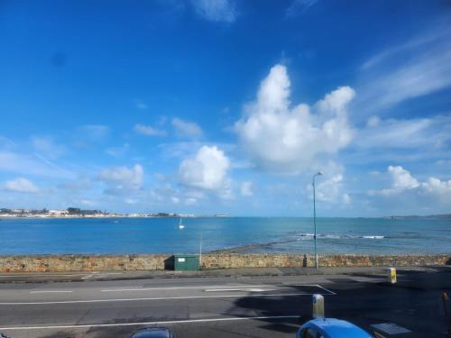 a view of the ocean from a parking lot at St Georges Guest House in St Peter Port