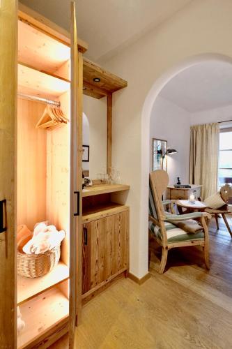 a room with a bed and a desk and a chair at Hotel Maier zum Kirschner in Rottach-Egern