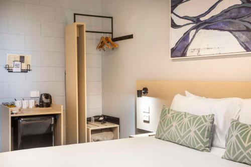 a hotel room with a bed and a desk at Nightcap at Rex Hotel in Adelaide