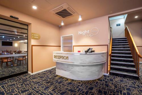 a lobby of a hotel with a reception desk at Nightcap at Rex Hotel in Adelaide