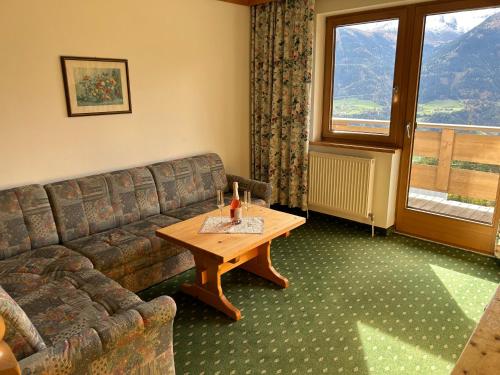 ein Wohnzimmer mit einem Sofa und einem Tisch in der Unterkunft Meilerhof in Reith bei Seefeld