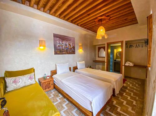 a bedroom with two beds in a room at Riad El Pacha in Rabat