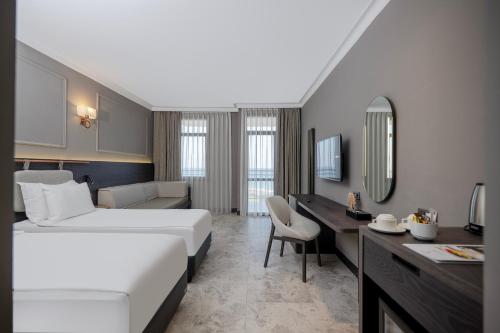 a hotel room with a bed and a desk at Adora Hotel & Resort in Belek