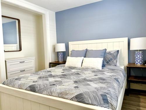 a bedroom with a large bed with blue walls at "Hike" at Hills Meaford, Pet Friendly, 2BD Suite in Meaford