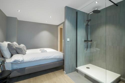 a bedroom with a bed and a glass shower at AmazingApartment#4Bedrooms#Bastille#PlaceDesVosges in Paris