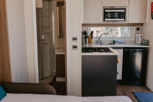 a small kitchen with a sink and a stove at Studio Pod 1 in Portland