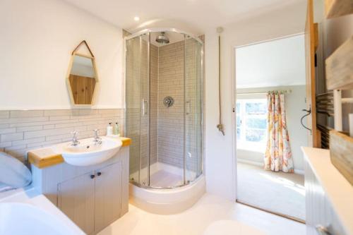 a bathroom with a shower and a sink at Peaceful Riverside Five Bed Cottage in Somerset in Langport