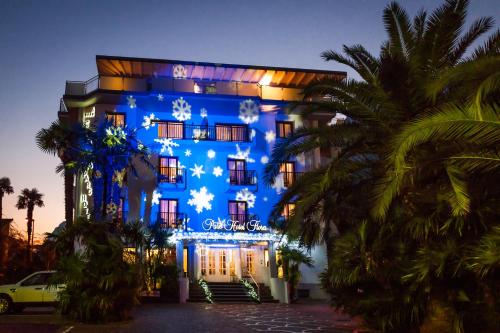 a blue building with christmas lights on it at Parc Hotel Flora S in Riva del Garda