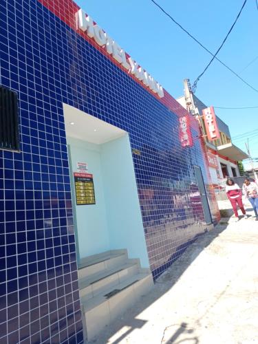 a blue tiled building with a white door at hotel xandu in São Paulo