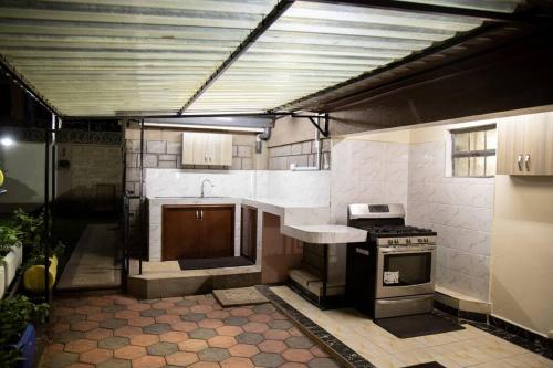a kitchen with a stove and a sink at Opal oasis Residence two in Nairobi