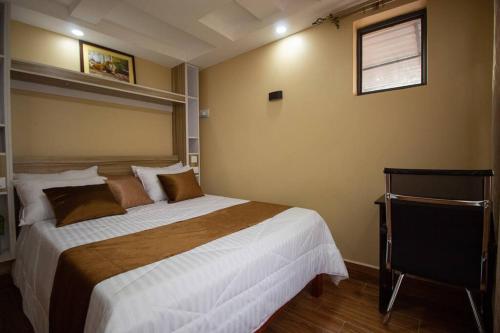 a bedroom with a large bed and a window at Opal oasis Residence two in Nairobi