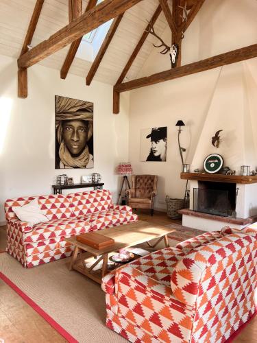 a living room with two couches and a fireplace at Landhaus Litschau in Litschau