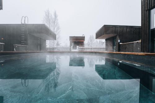a pool of water in front of a building at Panorama Landscape Hotel in Nilsiä